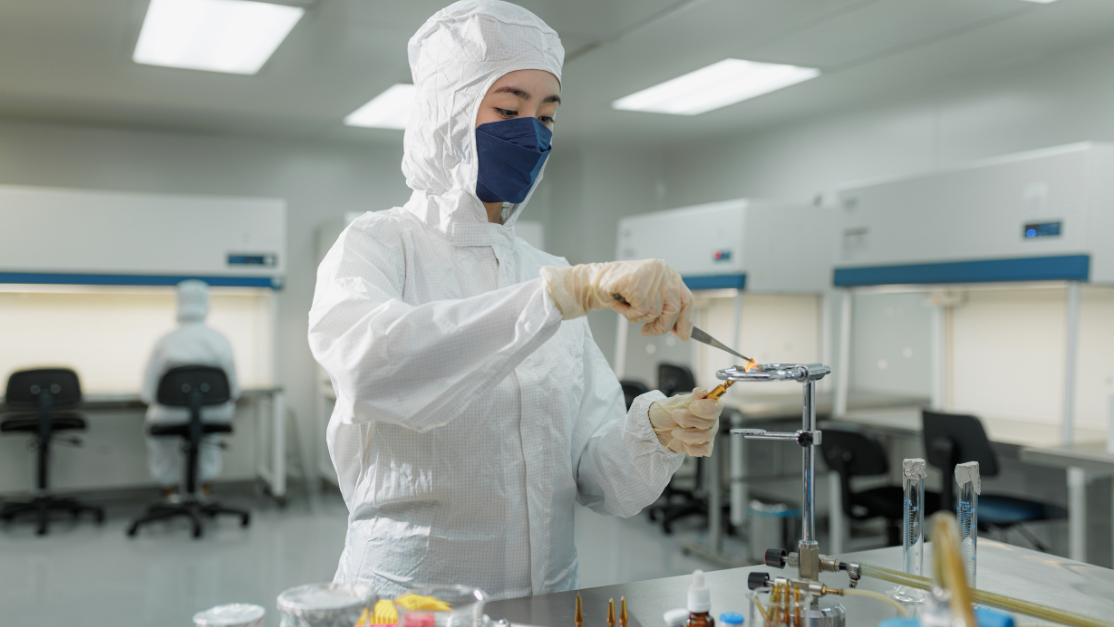 student clad in ppe working in a sterilised area