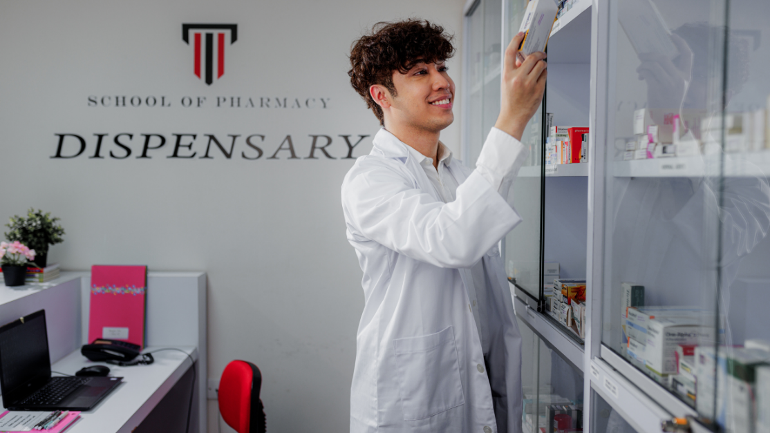 man picking an item from the dispensary shelf