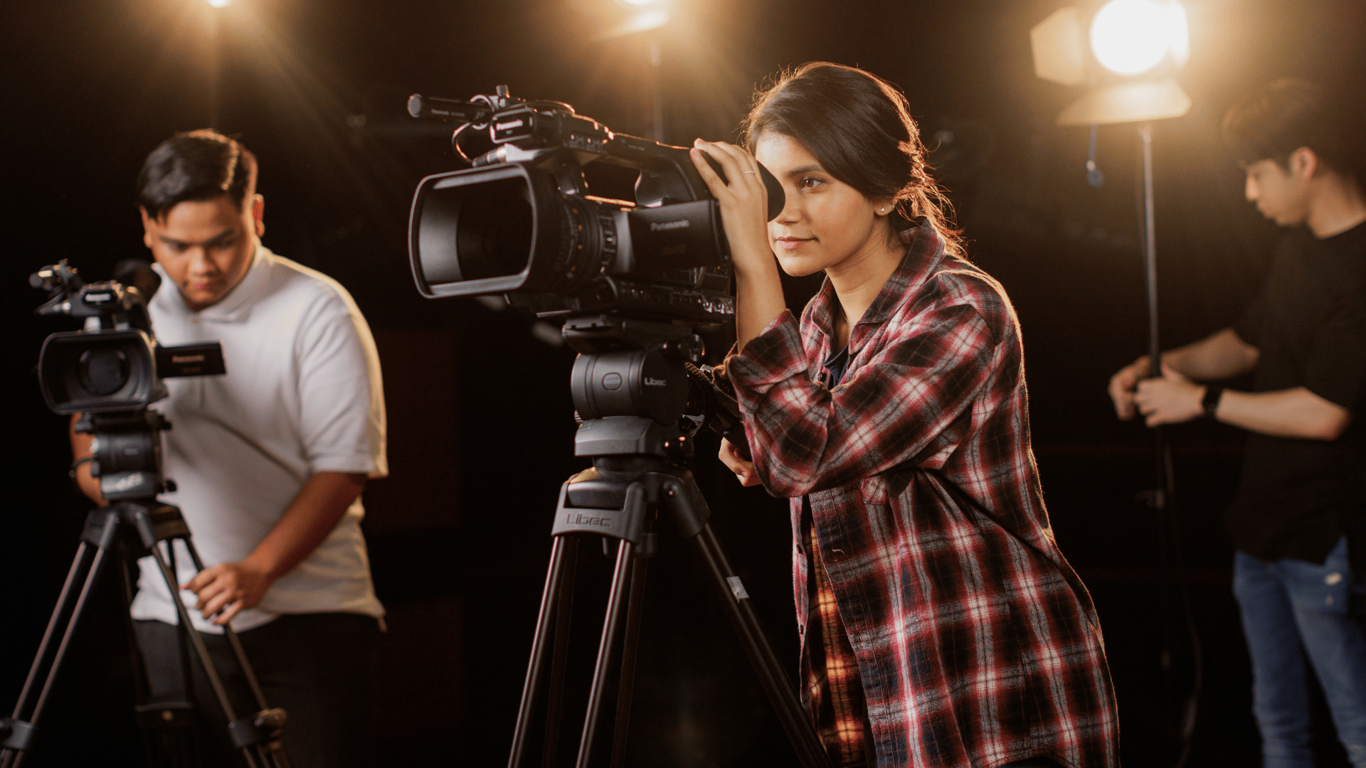 Female adjusting her broadcast camera