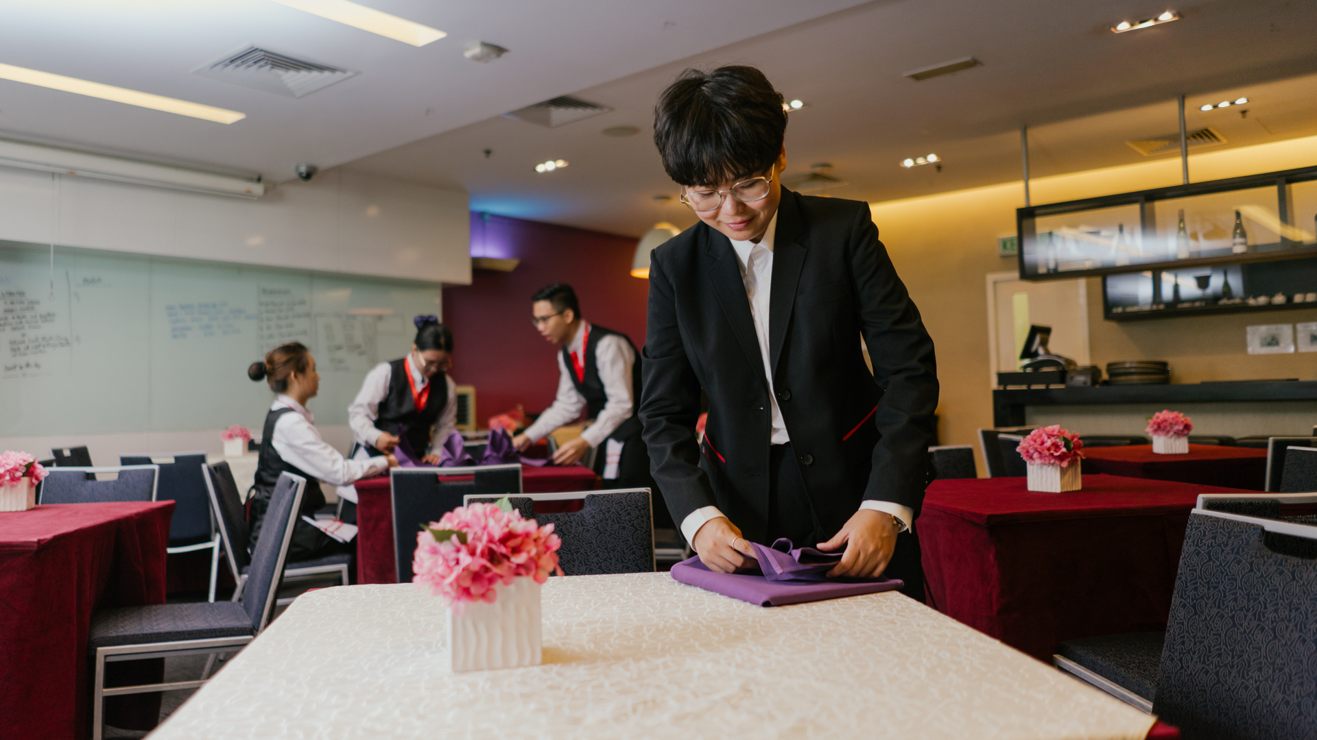 Student learning to fold wipes through hotel management 