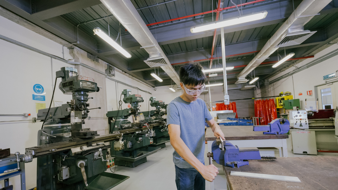 a student working with engineering  machinery