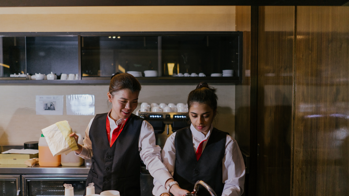 2 students working behind the bar