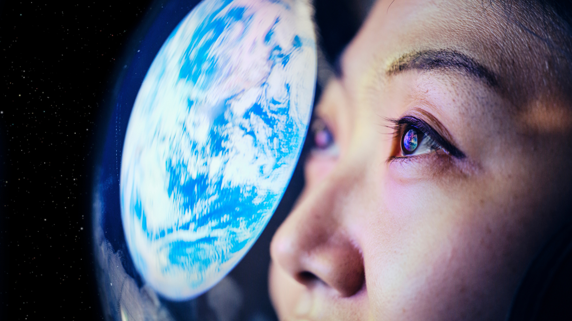 Astronaut looking at the reflection of the earth
