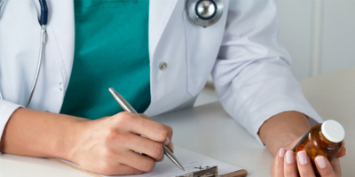 Doctor writing on a paper