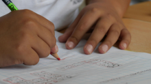 Hand of a child writing