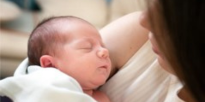 Young infant sleeping with mum