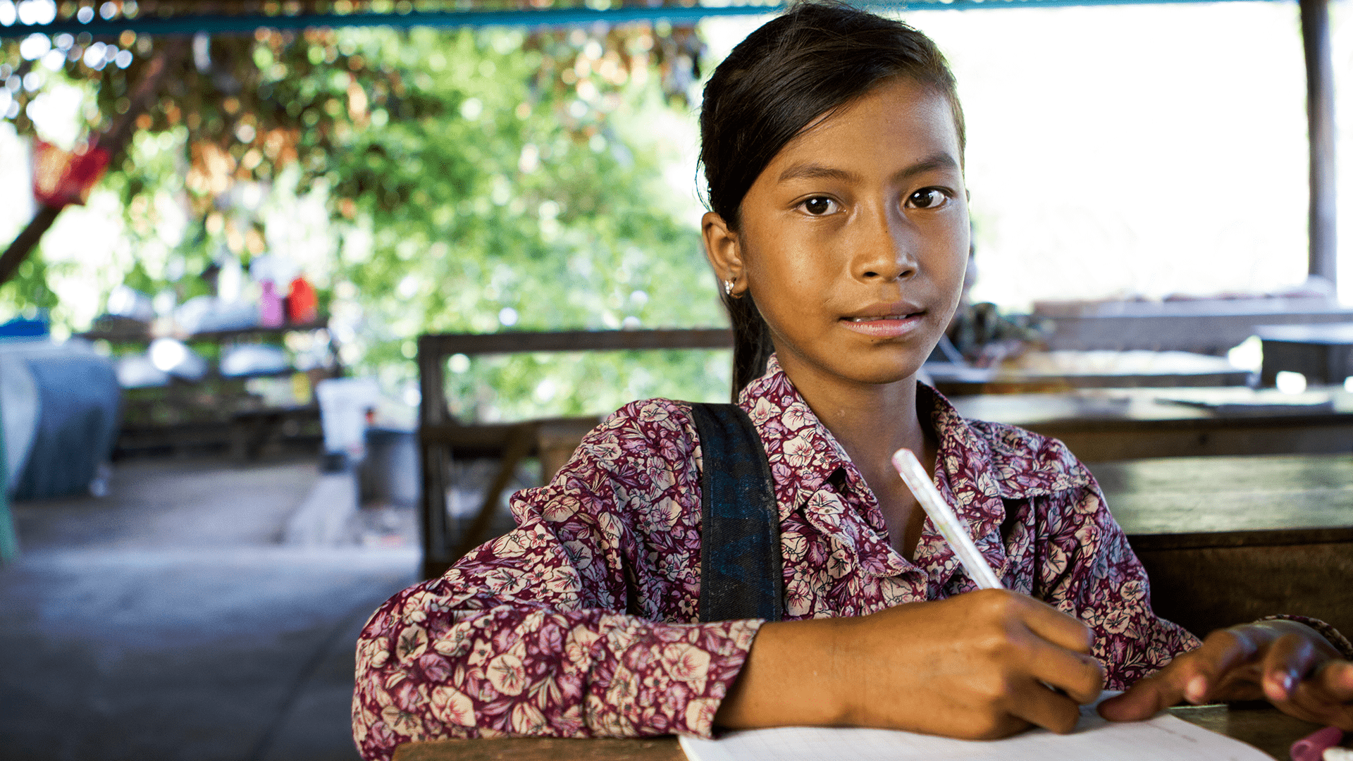 A young child from rural village attending a class