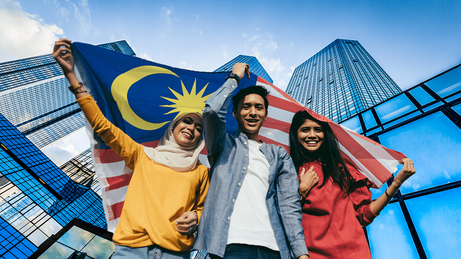 Young chinese, malay and indian holding malaysian flag