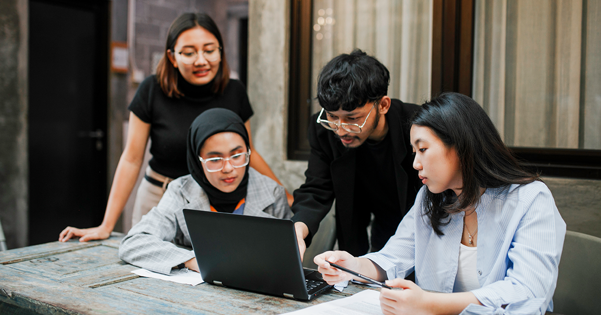 Four student looking at the computer screen, brainstorming for ideas