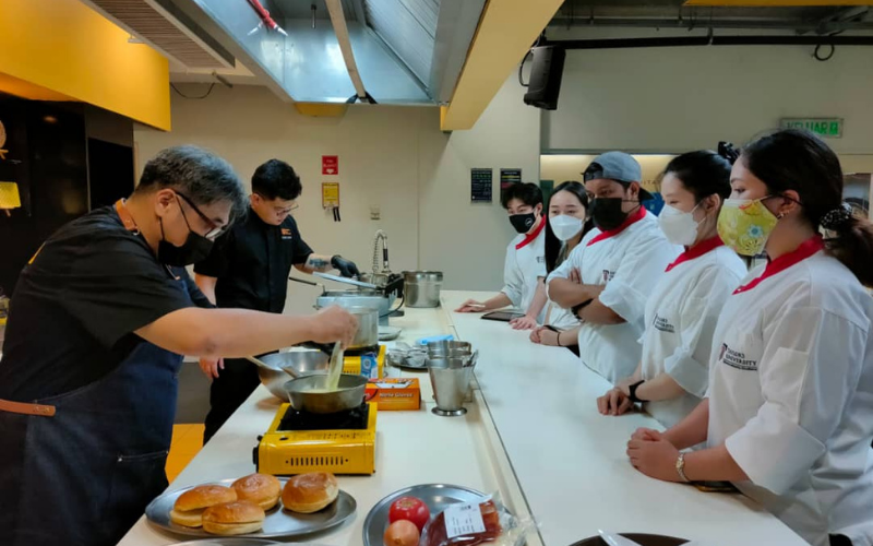 Chef showing student on preparation for the dishes