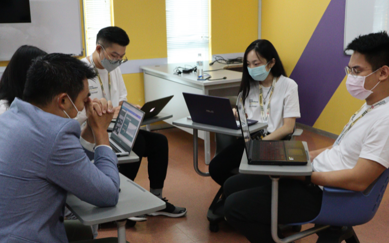 Group of student practicing business pitch with Dr Ingky