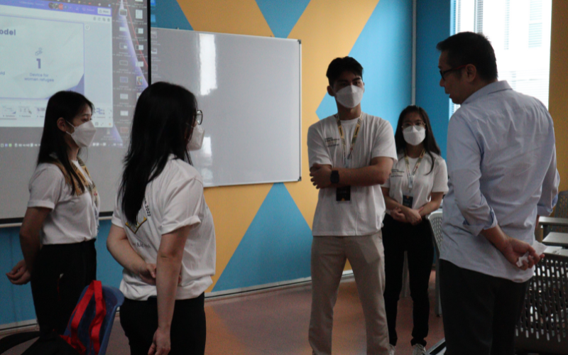Student having practice session with mentor, Mr Yip