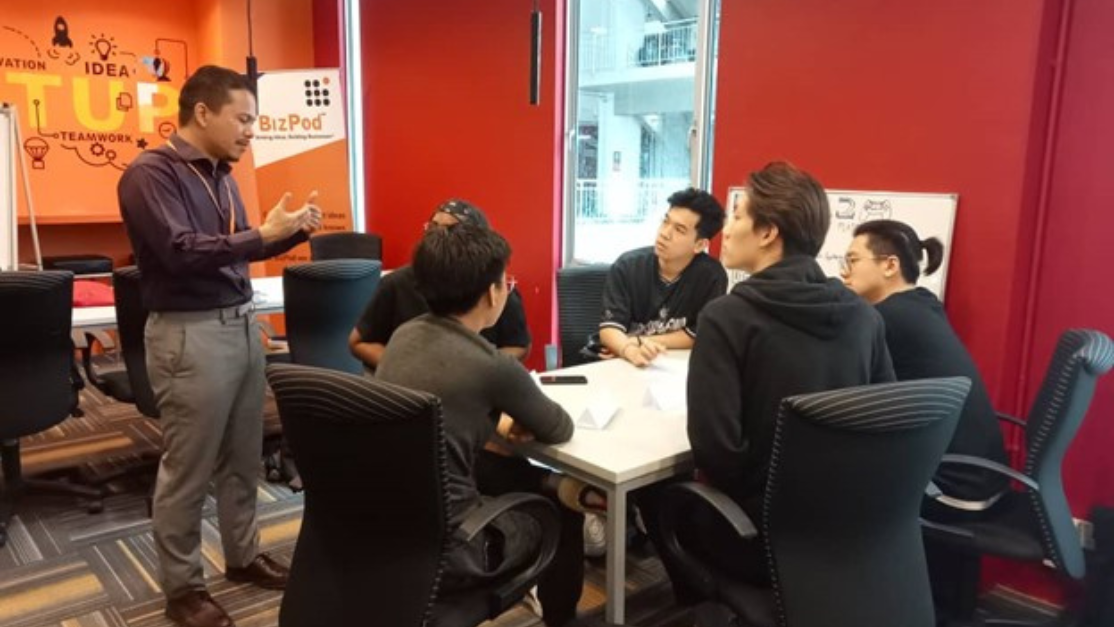 Photo of group of students discussing with Speaker