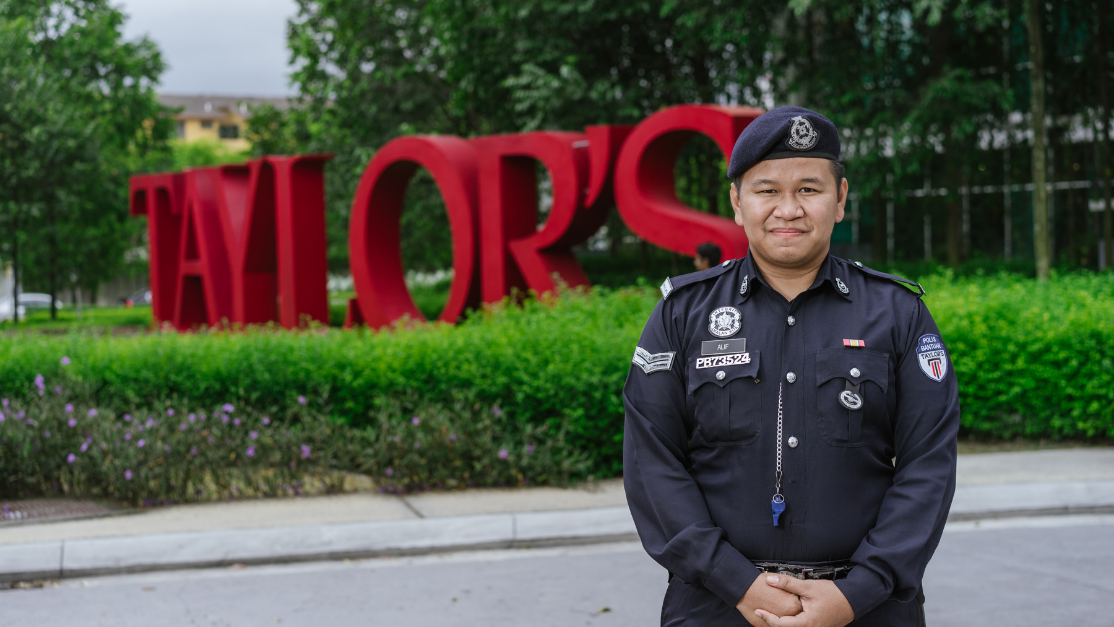 a policeman standing in front of taylors sign