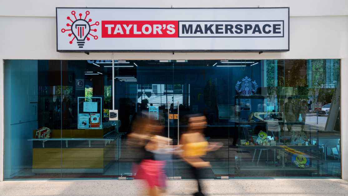 students walking past taylors makerspace