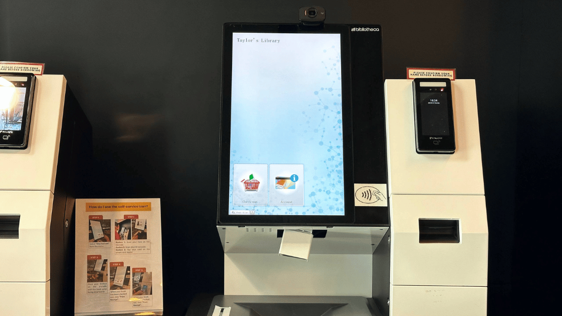 a girl using a self service book return machine