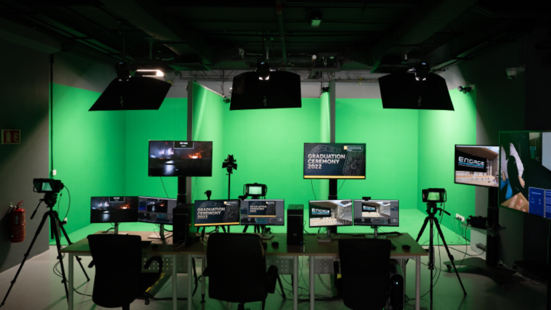 high tech machinery and monitors before a green screen