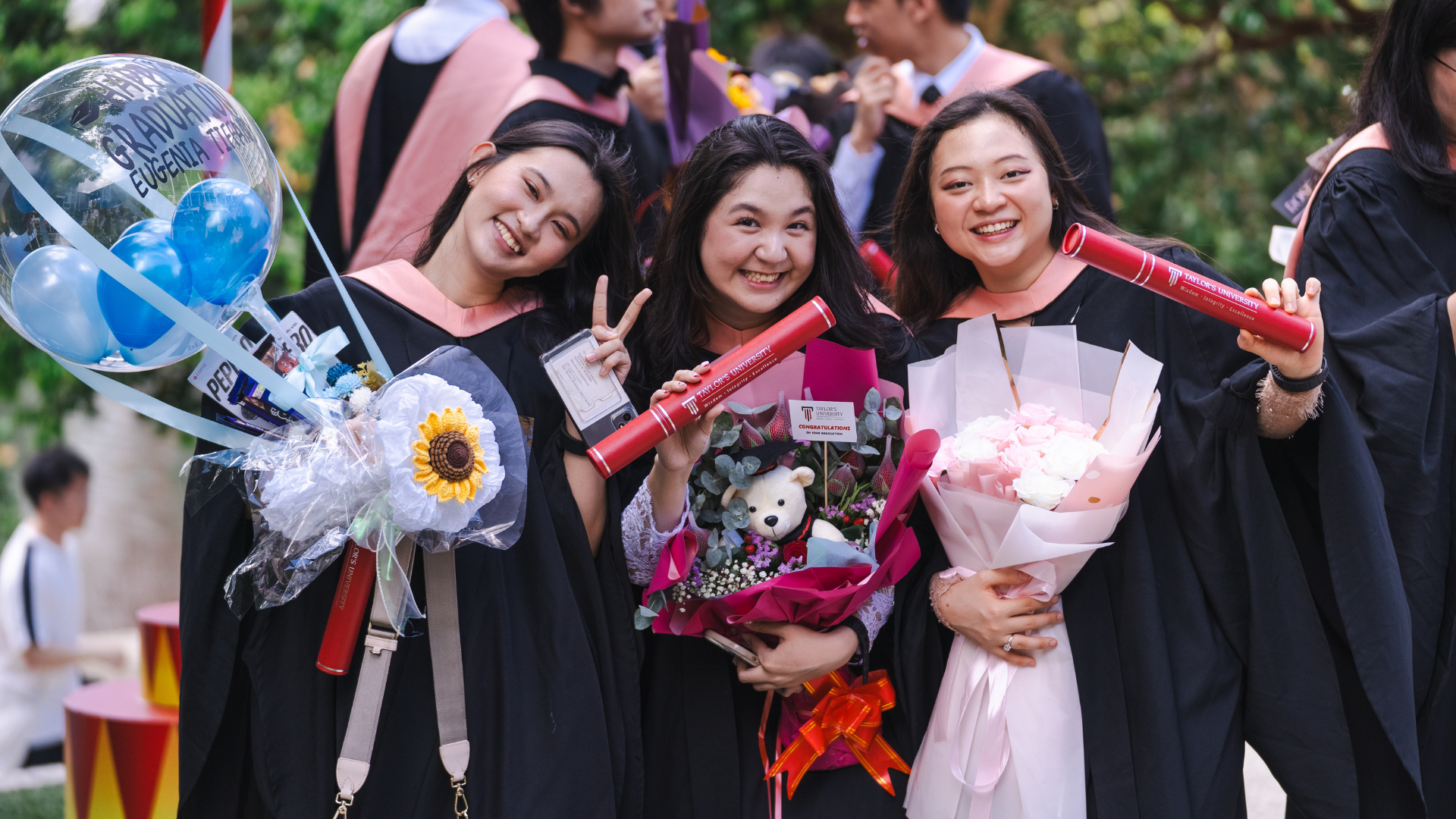 3 girls are taking picture during their graduation day