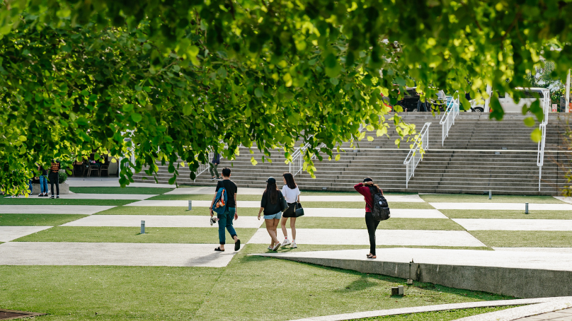 a group of students walking on taylors ampitheatre