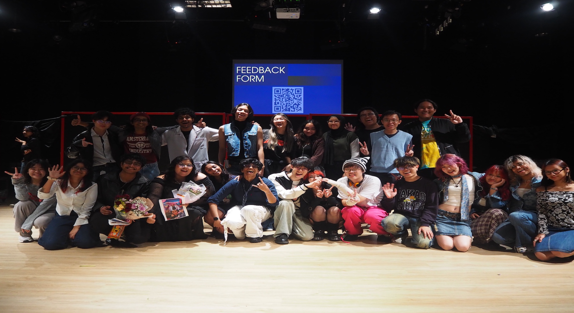 students posing for photo after a rehearsal session