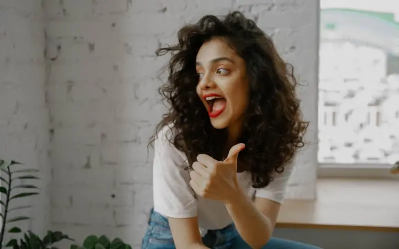 women posing with a thumbs up