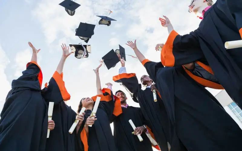 Graduating Students Throwing Hats in Air