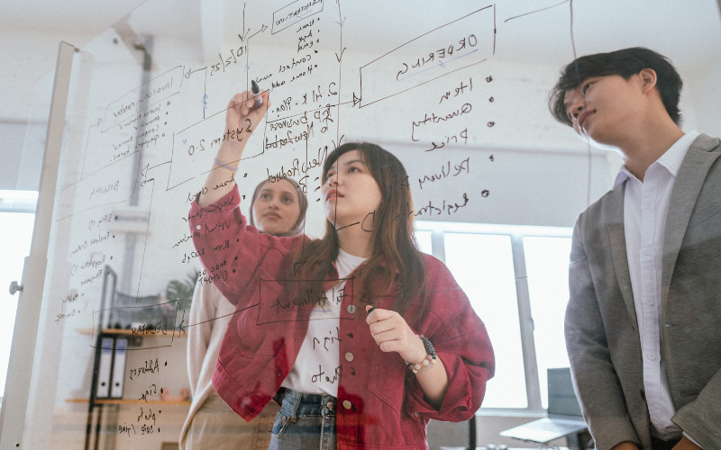 Students writing on board