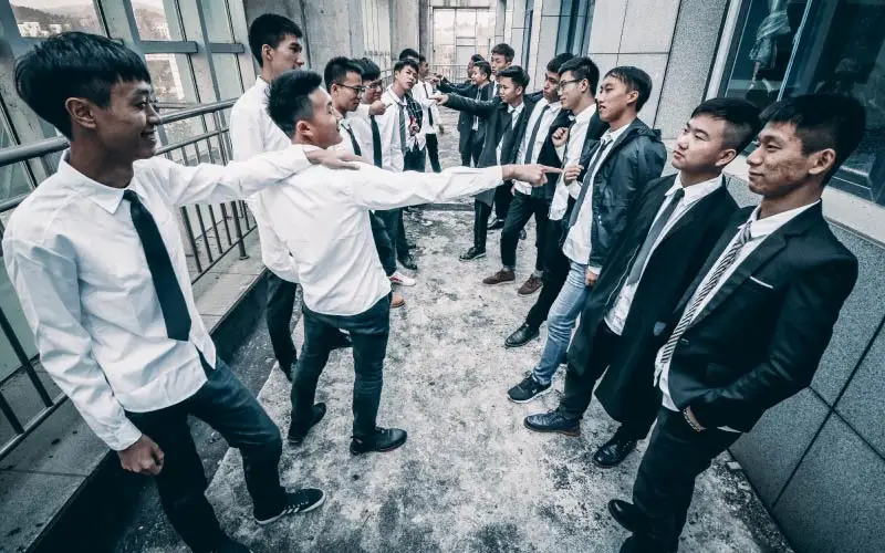 two groups of male pupils arguing