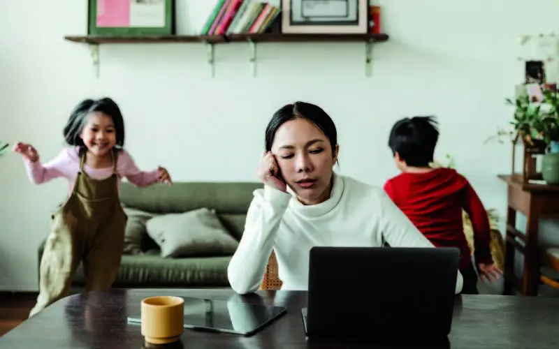 mom with kids playing in the back