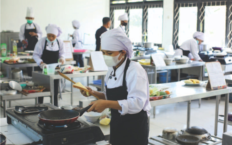 Culinology students cooking in a mass kitchen