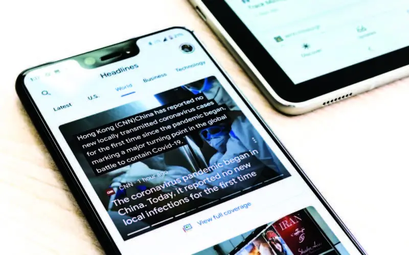 phone displaying headlines