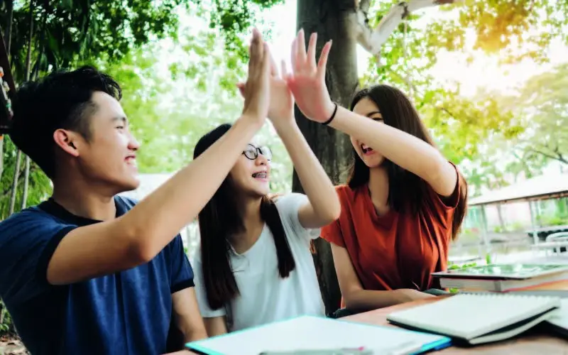 students high-fiving