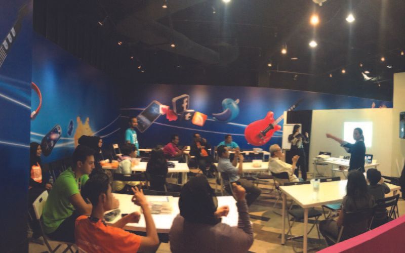 Ts. Dr. Pouline teaching sign language at a Petronas science festival.