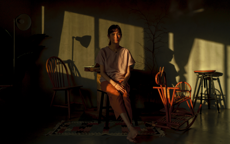 woman sitting in dark room