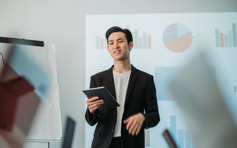 man presenting with statistics in the background