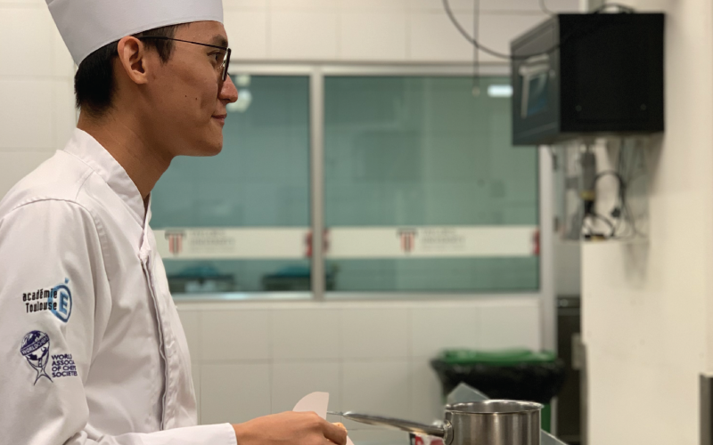 a focused participant in the macaron decorating workshop