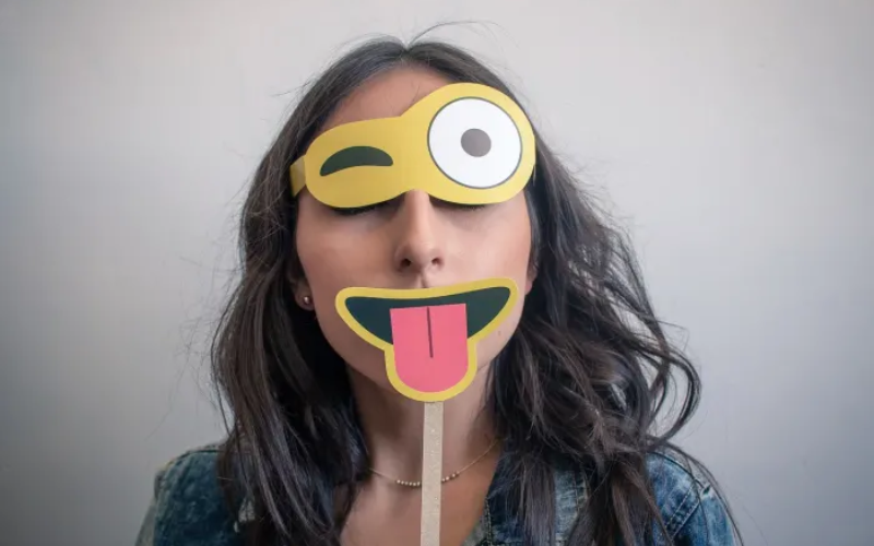 Woman holding props near her face