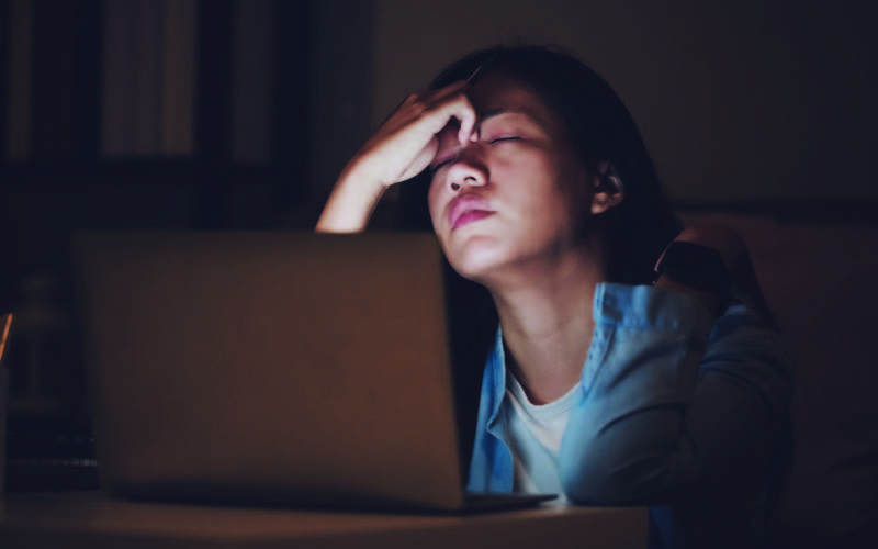 A new Master's student stressed as she completes her assignments on a computer.