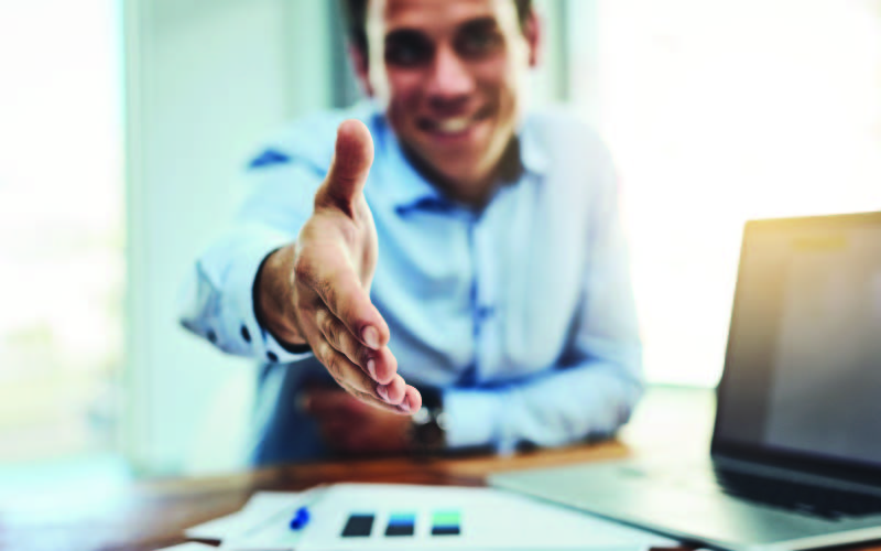 An job interviewer offering a handshake after a successful interview