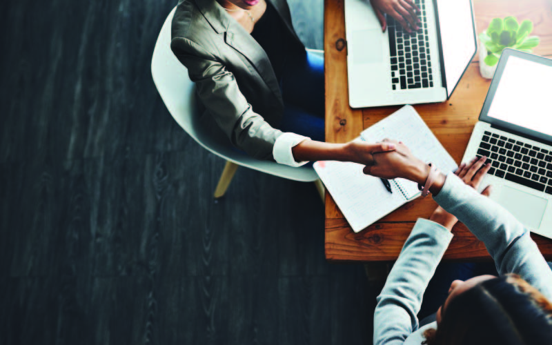 Two business people gibing each other a handshake over a business agreement