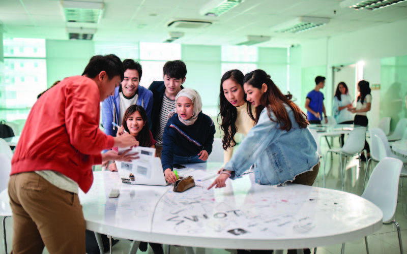 A group of international business and marketing students solving a problem together