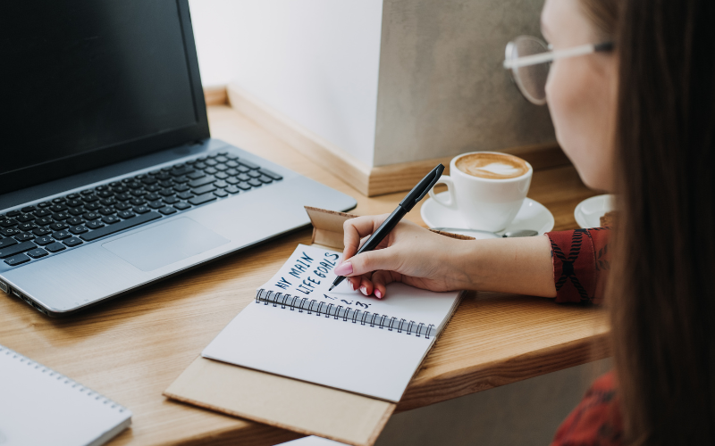 Close-up of a person writing the notes