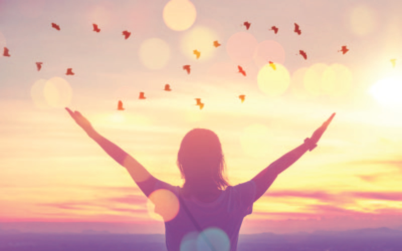 Content girl with a beautiful sky and birds flying