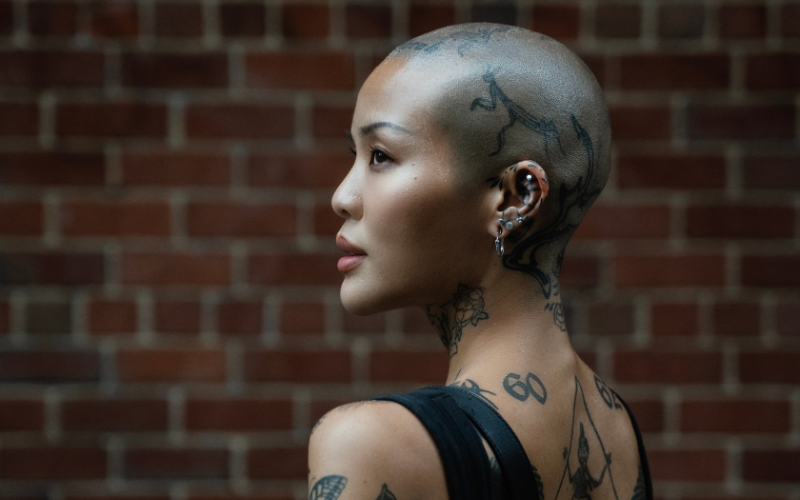 Bald woman with tattoos