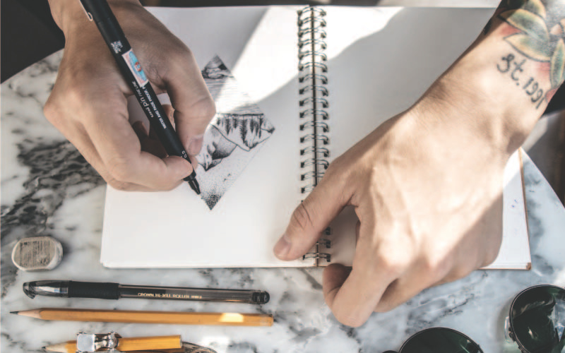 Tattoo artist drawing a design