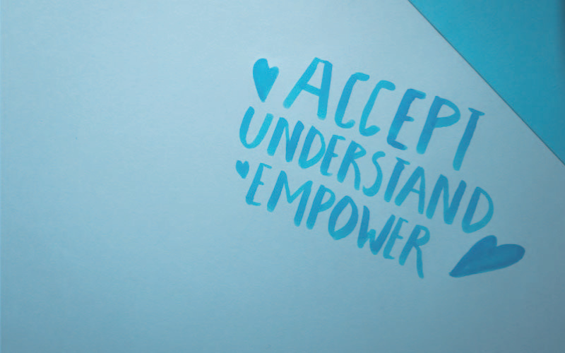 Accept, understand, empower written in blue on a piece of paper