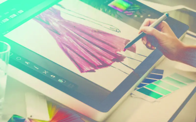 Wacom tablet displaying the artistic sketch of a red dress