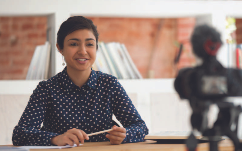 An Indian girl practising and prepping herself for a scholarship interview in front of a camera