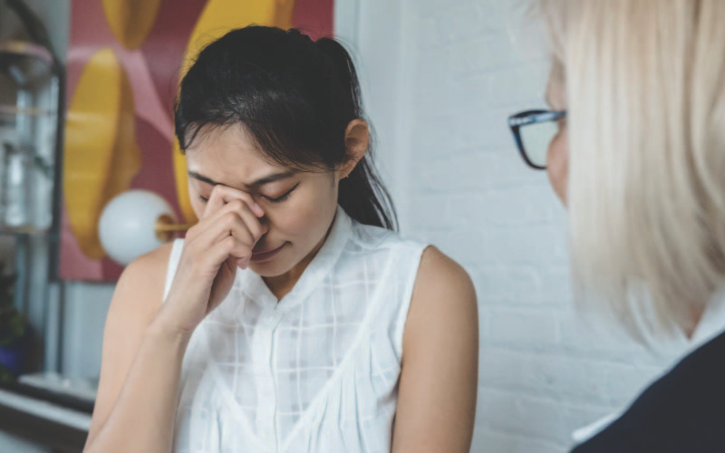 A girl experiencing grief sharing her feelings with a counsellor