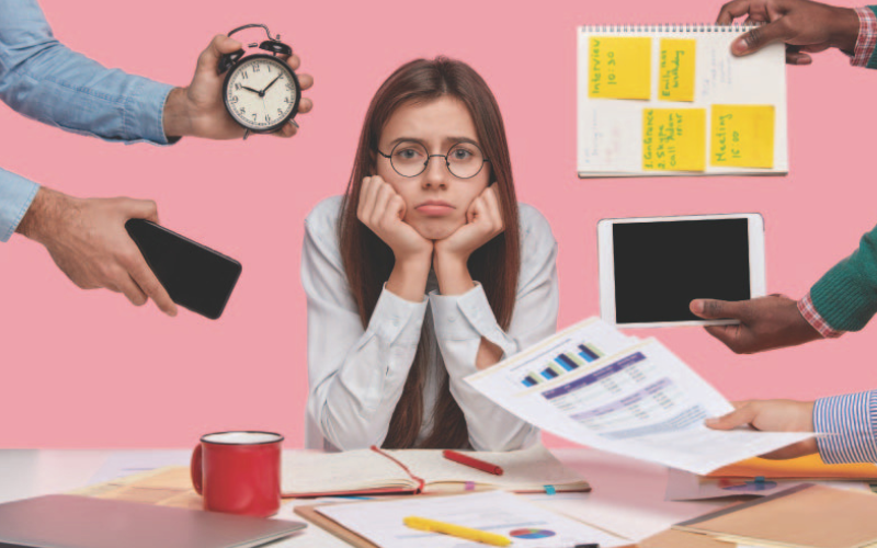 A girl looking defeated as she try to multitask all that she has to do